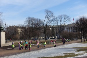 Each class of kids playing has a different colored vest on 